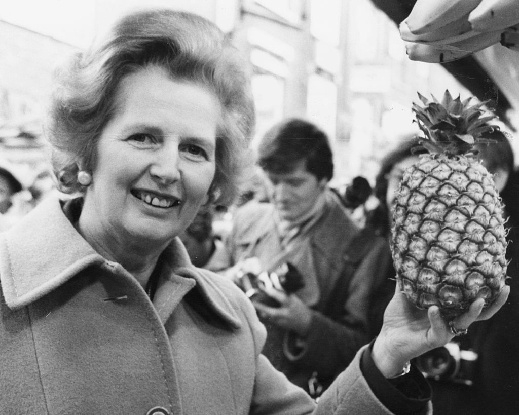 Margaret Thatcher holding up a pineapple
